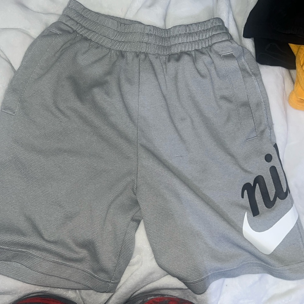 Grey Nike shorts unisex barley used they go to my knees I’m a size extra small